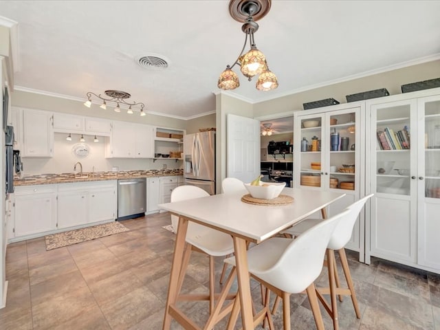 1318 Sue Dr, Lufkin, TX 75901 - dining space featuring ornamental molding and a ceiling fan