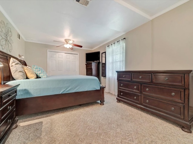 1318 Sue Dr, Lufkin, TX 75901 - bedroom featuring light carpet, a ceiling fan, a closet, and ornamental molding