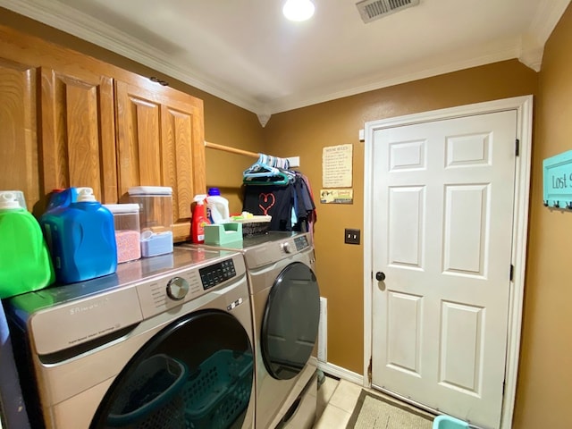 clothes washing area featuring crown molding, independent washer and dryer, and light tile patterned flooring