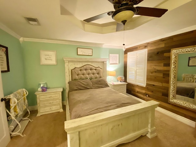 bedroom with ceiling fan, wooden walls, and ornamental molding