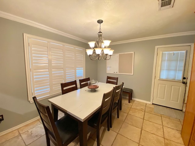 dining area featuring ornamental molding and an inviting chandelier