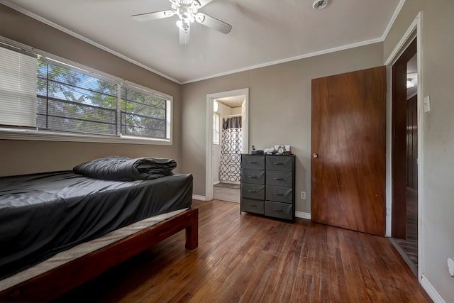 bedroom featuring ceiling fan, dark hardwood / wood-style flooring, and crown molding