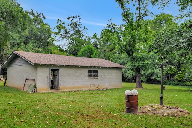 view of outbuilding with a lawn