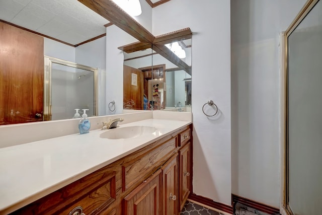 bathroom featuring crown molding, vanity, and walk in shower