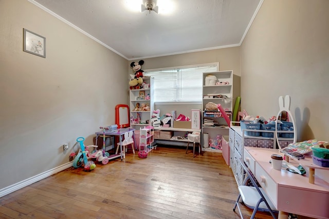 playroom with hardwood / wood-style floors and ornamental molding