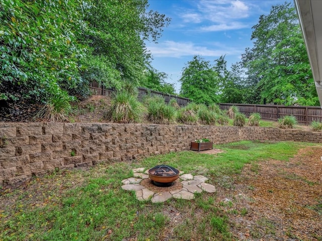 view of yard with an outdoor fire pit