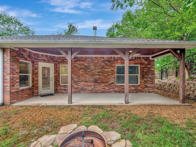 back of house featuring a fire pit and a patio