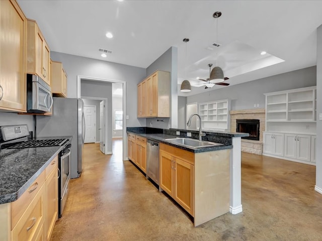 kitchen with kitchen peninsula, light brown cabinetry, stainless steel appliances, and sink