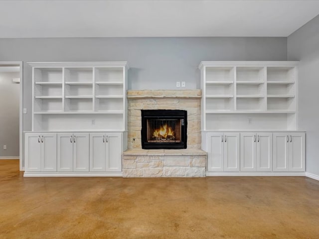 unfurnished living room featuring a stone fireplace and light carpet