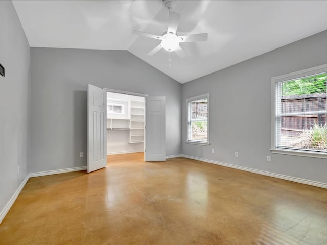 interior space with ceiling fan, a healthy amount of sunlight, and lofted ceiling