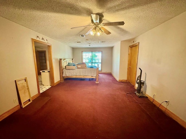 179 County Road 4587, Spurger, TX 77660 - unfurnished bedroom featuring carpet floors, baseboards, a textured ceiling, and ceiling fan