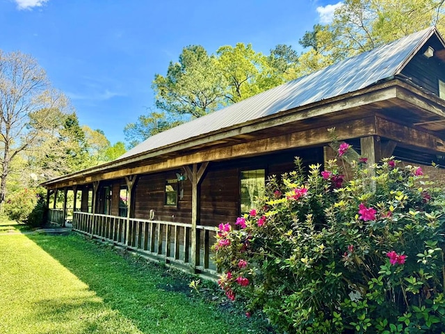 179 County Road 4587, Spurger, TX 77660 - view of side of home with metal roof and a lawn