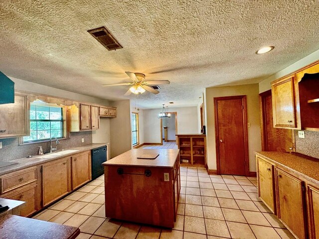 179 County Road 4587, Spurger, TX 77660 - kitchen featuring a sink, dishwasher, a ceiling fan, light tile patterned flooring, and a textured ceiling