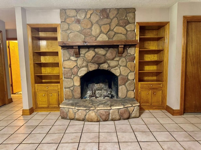 179 County Road 4587, Spurger, TX 77660 - detailed view of a textured ceiling, built in shelves, baseboards, and a stone fireplace