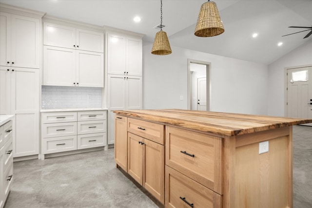 kitchen featuring wooden counters, recessed lighting, decorative backsplash, vaulted ceiling, and hanging light fixtures