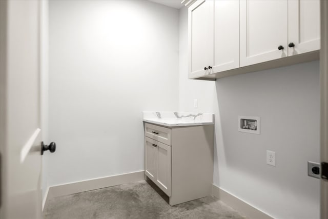 washroom with hookup for a washing machine, cabinet space, baseboards, and hookup for an electric dryer