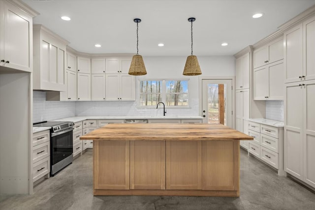 kitchen featuring butcher block countertops, stainless steel range with electric stovetop, concrete floors, and a sink