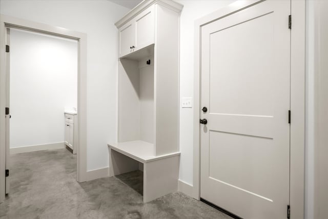 mudroom featuring baseboards and concrete floors