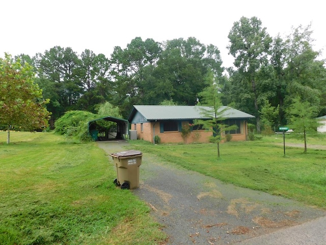 single story home featuring a carport and a front yard