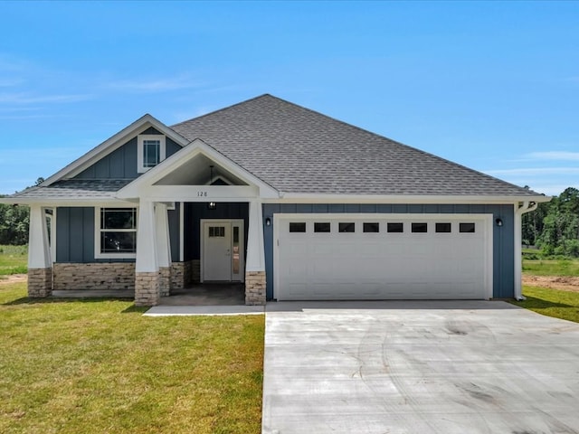 128 Stoney Rdg, Lufkin, TX 75904 - view of front facade featuring a shingled roof, driveway, board and batten siding, an attached garage, and a front lawn