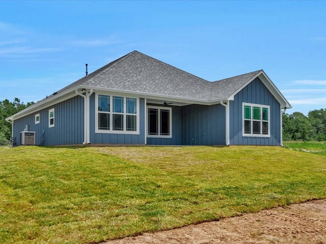 128 Stoney Rdg, Lufkin, TX 75904 - back of house featuring a lawn, board and batten siding, a shingled roof, and ceiling fan