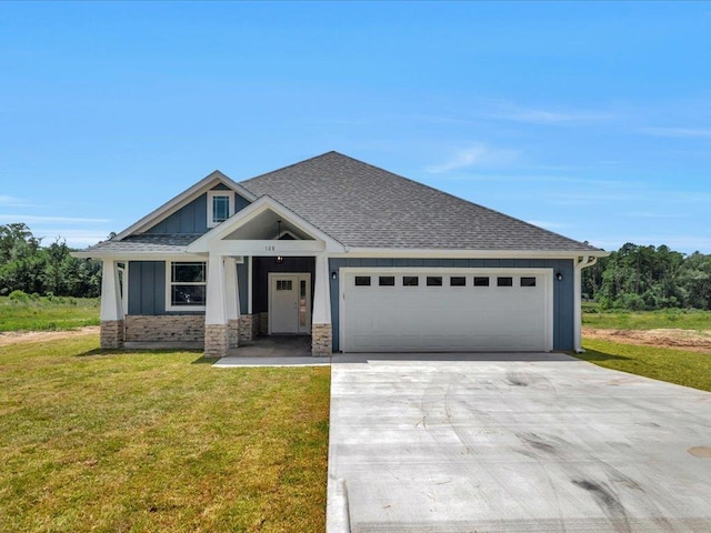 128 Stoney Rdg, Lufkin, TX 75904 - view of front of property with concrete driveway, board and batten siding, a garage, and a front lawn
