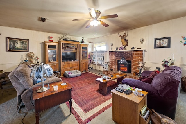 carpeted living room featuring ceiling fan and a fireplace