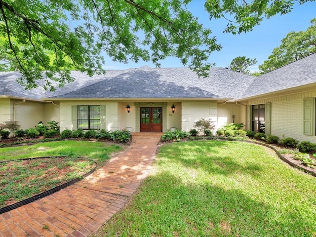 5078 US Highway 21, Nacogdoches, TX 75964 - ranch-style house with french doors, a front yard, roof with shingles, and brick siding