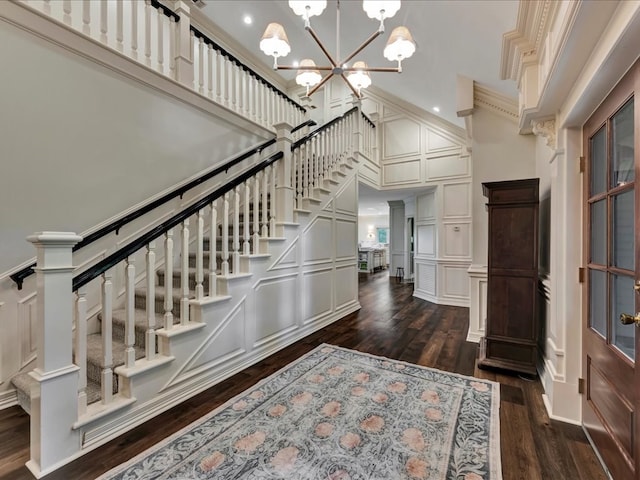 5078 US Highway 21, Nacogdoches, TX 75964 - entryway with a decorative wall, a towering ceiling, stairs, dark wood-style flooring, and ornamental molding