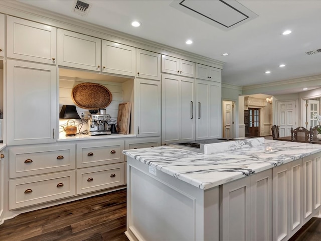 5078 US Highway 21, Nacogdoches, TX 75964 - kitchen with crown molding, dark wood finished floors, a center island, recessed lighting, and light stone counters