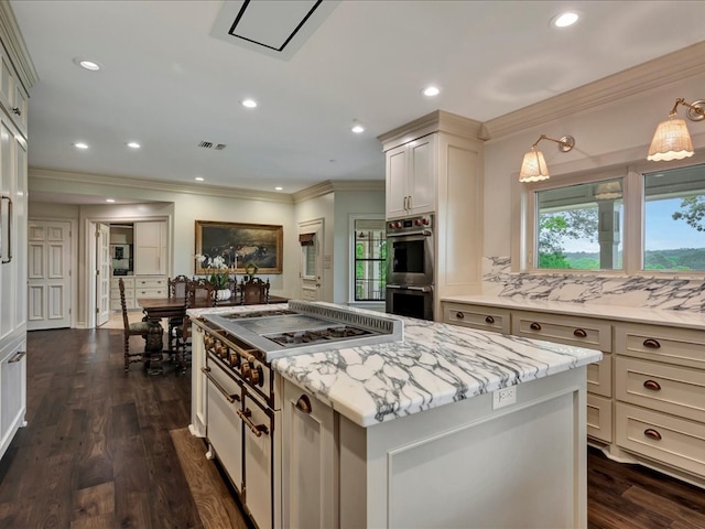5078 US Highway 21, Nacogdoches, TX 75964 - kitchen with double oven, ornamental molding, dark wood finished floors, a kitchen island, and light stone counters
