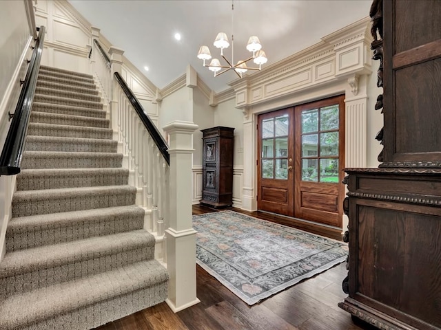 5078 US Highway 21, Nacogdoches, TX 75964 - foyer entrance with stairs, dark wood-type flooring, crown molding, a decorative wall, and vaulted ceiling