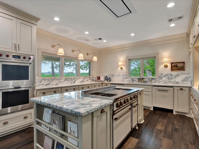 5078 US Highway 21, Nacogdoches, TX 75964 - kitchen with stainless steel double oven, gas stove, healthy amount of natural light, crown molding, and decorative backsplash