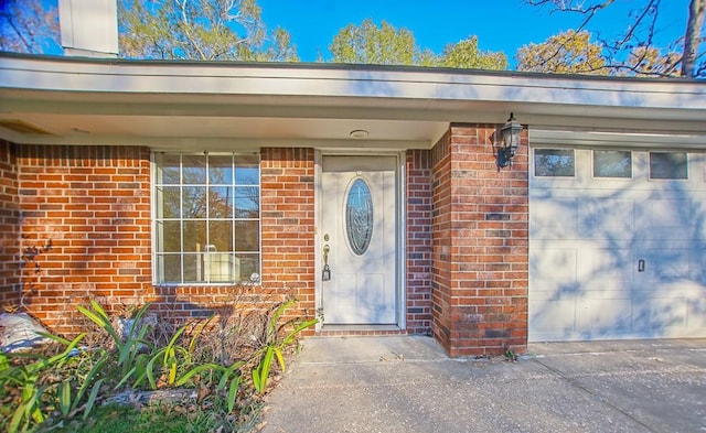 view of exterior entry with a garage