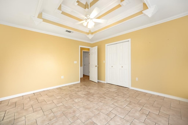 unfurnished bedroom featuring a tray ceiling, ceiling fan, and ornamental molding