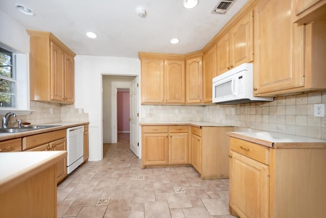 kitchen with decorative backsplash, light brown cabinetry, white appliances, and sink