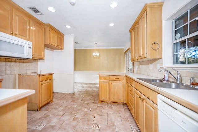 kitchen featuring sink, a chandelier, pendant lighting, white appliances, and decorative backsplash