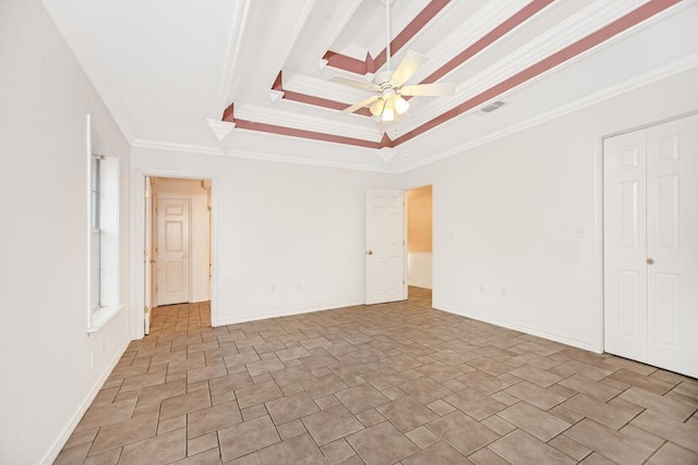 spare room featuring ceiling fan, ornamental molding, and a tray ceiling