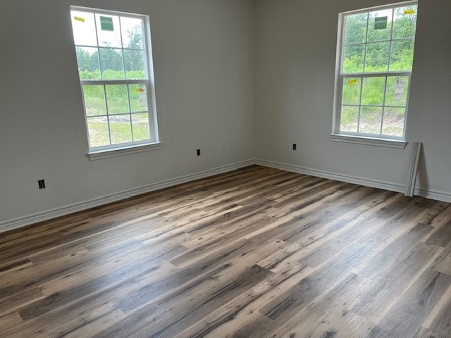 unfurnished room with dark hardwood / wood-style floors