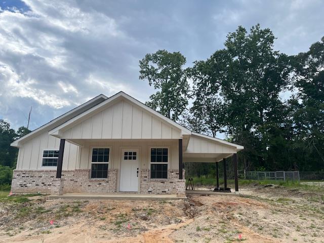 view of front of house with a carport and a porch