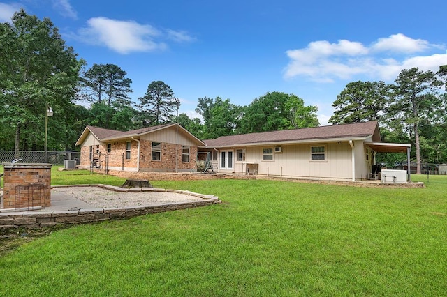 back of house featuring a yard and fence