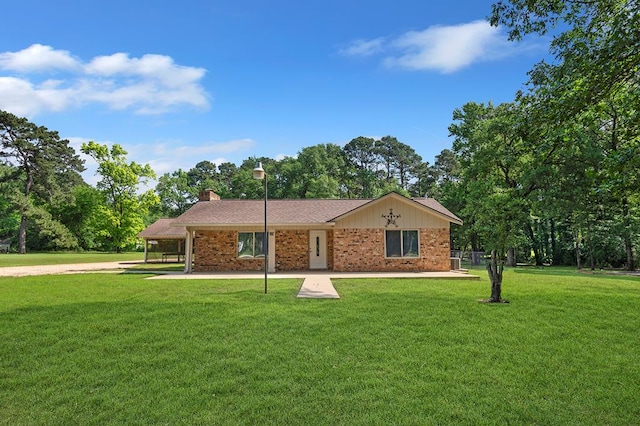 single story home with brick siding, a chimney, and a front lawn