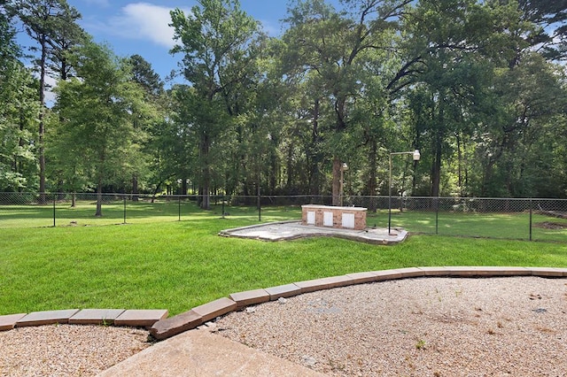exterior space featuring a lawn and fence