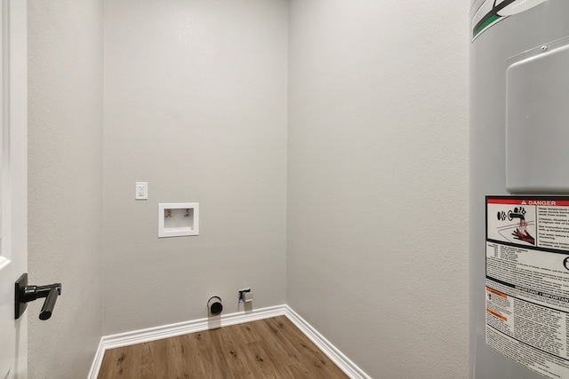 131 Oak Ln, Hemphill, TX 75948 - washroom featuring electric water heater, baseboards, washer hookup, laundry area, and wood finished floors