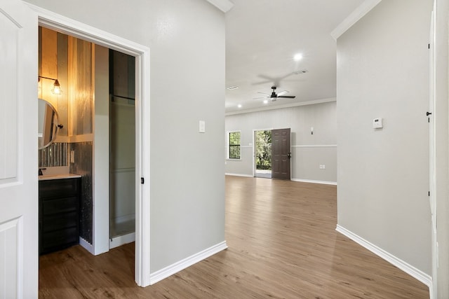 131 Oak Ln, Hemphill, TX 75948 - corridor featuring baseboards, wood finished floors, and ornamental molding