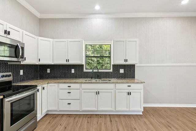 131 Oak Ln, Hemphill, TX 75948 - kitchen with light stone counters, white cabinetry, stainless steel appliances, and a sink
