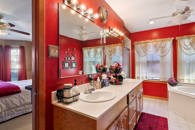 bathroom featuring a bathing tub, tile patterned flooring, and vanity