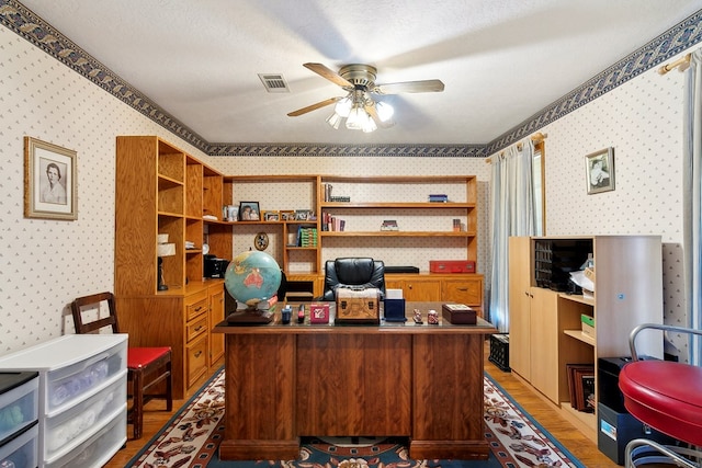 office space featuring wood-type flooring, a textured ceiling, and ceiling fan