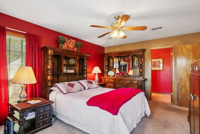 bedroom with light carpet and ceiling fan