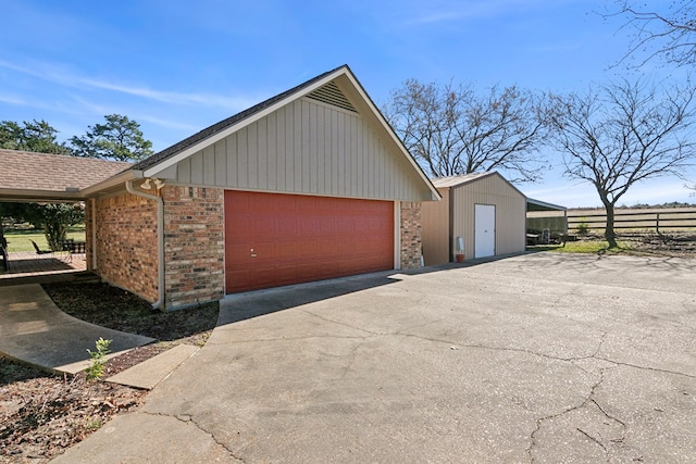 view of property exterior with a garage and an outdoor structure